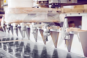 Machine with numerical control for cutting wood with various router bits.