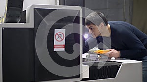 Machine Operator Enters the Data in industrial digital CNC Laser