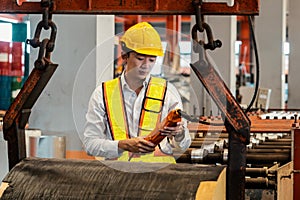 Machine operator skillfully operate steel forming machinery. Exemplifying