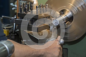 The machine operator working the lathe machine