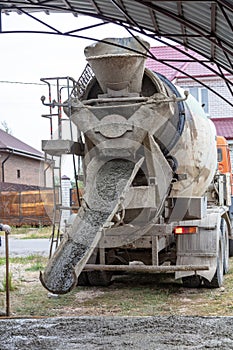 The machine is pouring concrete mix at a construction site.