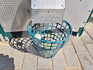 Machine pours golf balls into basket. Golfing