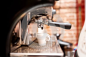 Machine preparing espresso in coffee shop