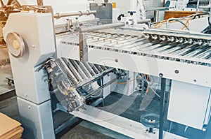 The machine in the printing, shiny rollers, broach paper