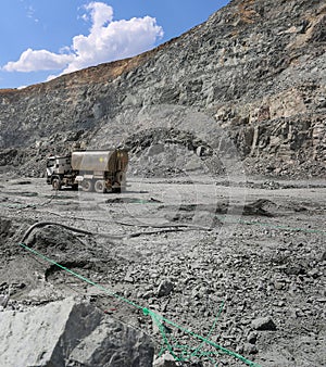 Machine pumps plastic explosives into  holes. Mining in quarry. photo