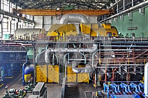 Machine room in thermal power plant with generators and turbines