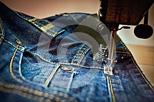A machine sewing a jean