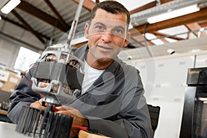 machine technician smiling at camera