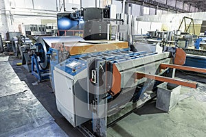 Machine tool with metal-roll sheet for metalwork in factory for production steel tubes and pipes for ventilation systems