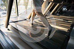 Machine treadmill with people running closeup at fitness gym