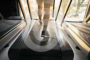 Machine treadmill with people running closeup at fitness gym