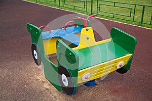 Machine wooden green yellow on the Playground with rubberized coating.