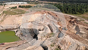 Machinery excavators digging and loading ore at quarry. Sand extraction at quarry. Operation of machinery in open pit mining of co