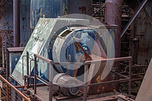 Machinery on exterior of an old steel manufacturing plant, heavy rust and paint patina