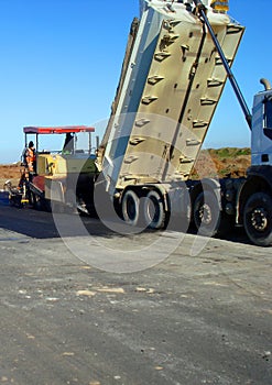 Machinery leveling bitumen and truck