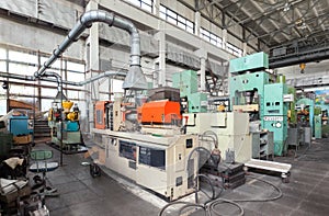 Machinery plant. Workshop for production of thermoplastic parts. Injection molding plastic machine and hydraulic press