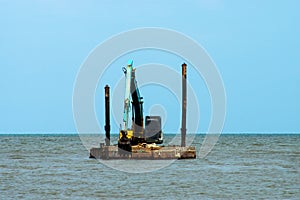 Machines are dredging sand in the sea
