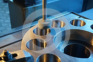 Machining of the internal hole on a coordinate grinding machine with sparks, in an industrial plant.