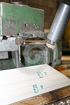 Machining a profile in a PVC joinery workshop photo