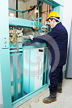Machinist with spanner adjusting lift mechanism