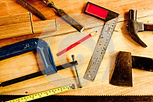 Machinist square , wood pencil, hammer, saw, clamp, Chisel, vise, tape measure, file for carpenter on wooden background tool wood