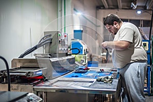 Machinist technician operating with automatic heater stove heating PVC machine