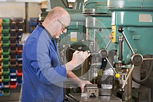 Machinist working on machine