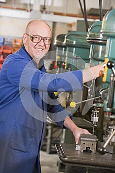 Machinist working on machine