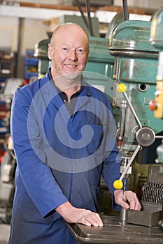 Machinist working on machine