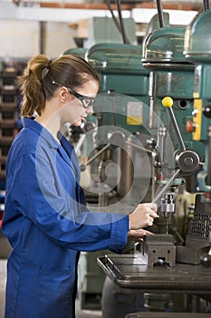 Machinist working on machine