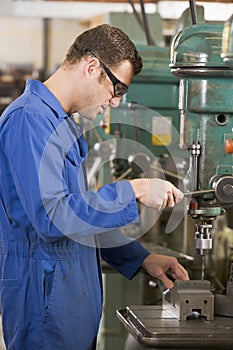 Machinist working on machine