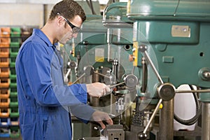 Machinist working on machine