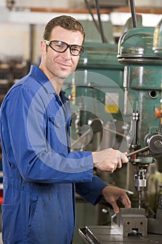 Machinist working on machine