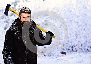 Macho with beard and mustache holds yellow ax.