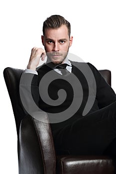 Macho businessman looking straight into camera sitting down