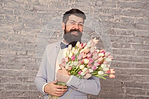 Macho getting ready romantic date. Waiting for darling. Tulips for sweetheart. Man well groomed wear tuxedo bow tie hold