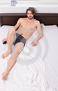 Macho guy underpants relaxing lay bedroom. Bed with white bedclothes and nude man copy space. Join him or share bed