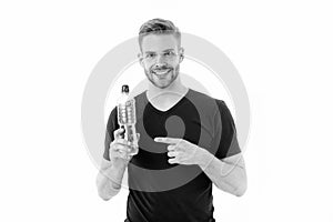 Macho point finger at water bottle isolated on white. Happy man smile with plastic bottle. Thirst and health. Stay