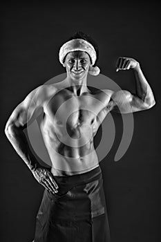 Macho sexy muscular torso posing confidently. Santa claus comes not only to good girls. Athlete man wear santa hat and