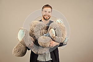 Macho smile with grey teddy bear. Happy man big animal toy. Man smile with big animal toy. Gift and present concept photo