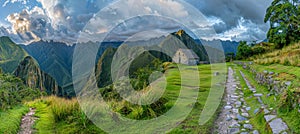 Machu picchu ancient incan citadel on andean mountain ridge with sunset panorama views