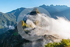 Machu Picchu site in sunrise mist covering the lost city of Incas, Cuzco, Peru, South America