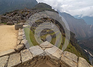 Machu Picchu terraces viewed from behind stone wall