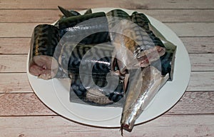 Mackerel cut into pieces, placed on a plate.