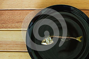 Mackerel fishbone on the black dish