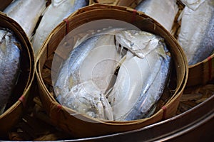 Mackerel fishes in round bamboo basket