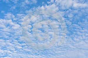 Mackerel sky with white clouds on day time for background usage