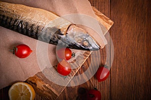 Mackerel on the table with vegetables. Home cooking, fish menu.