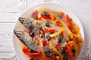 Mackerel in vegetable marinade close-up on the table. horizontal