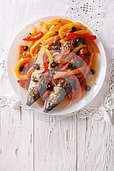 Mackerel in vegetable marinade close-up on the table. vertical t